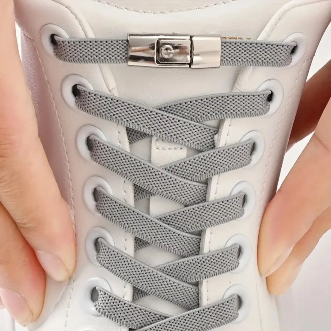 Close-up of grey no-tie elastic shoelaces with press lock