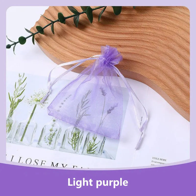 Assorted size FanzyMarket organza drawstring bags for jewelry and gifts, featuring delicate sheer fabric and elegant closures.