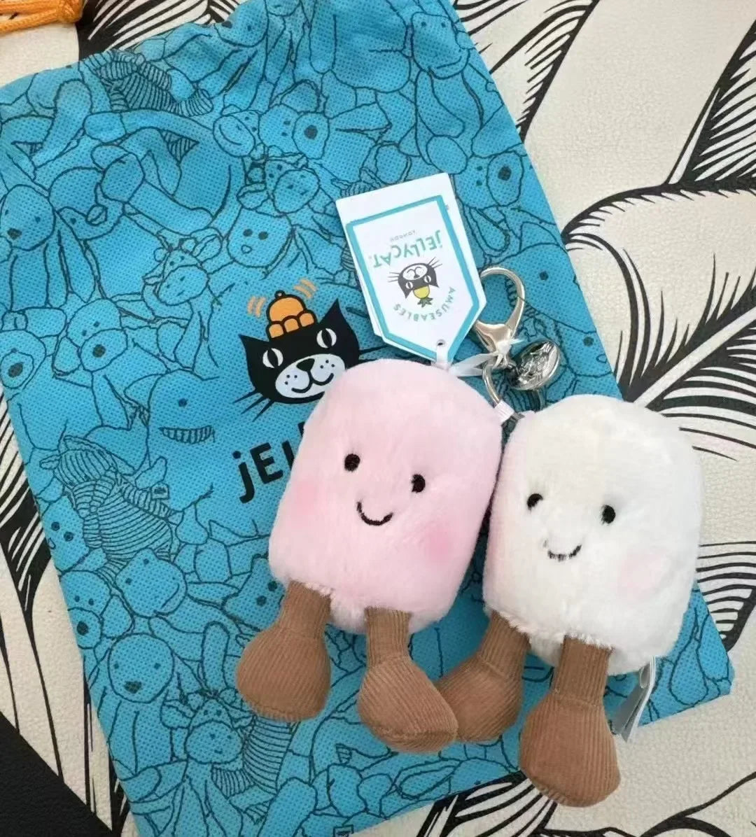 FanzyMarket plush cotton cat keychain with croissant and cherry charms, two-tone soft plush accessory for bags or keys