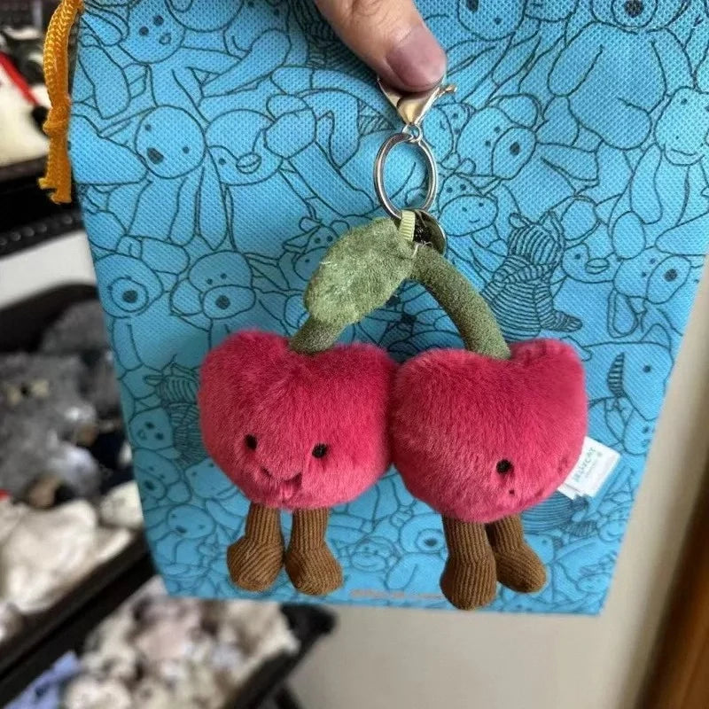 FanzyMarket plush cotton cat keychain with two-tone soft croissant and cherry charms, perfect for bags and accessories.