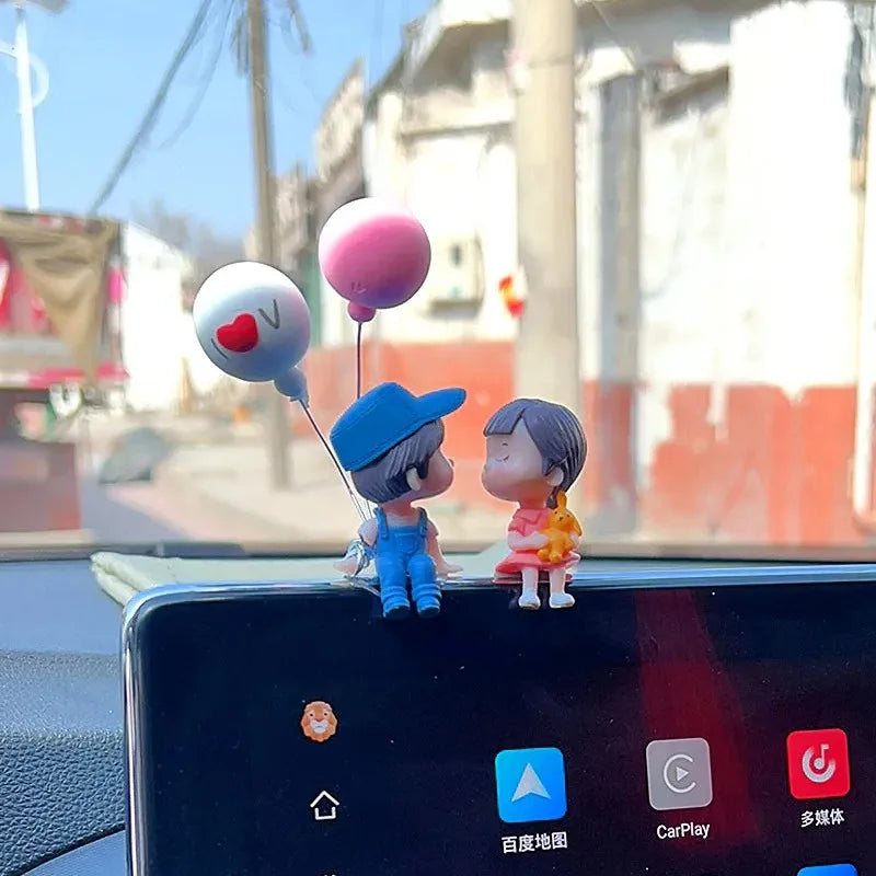 Cute cartoon couple dashboard figurines by FanzyMarket, with romantic balloon ornaments for car interior decoration.