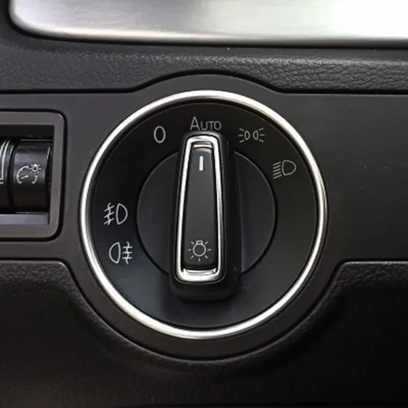 Silver metal headlight switch trim ring for car interior, fits Golf, Passat, Polo; stylish switch cover by FanzyMarket.