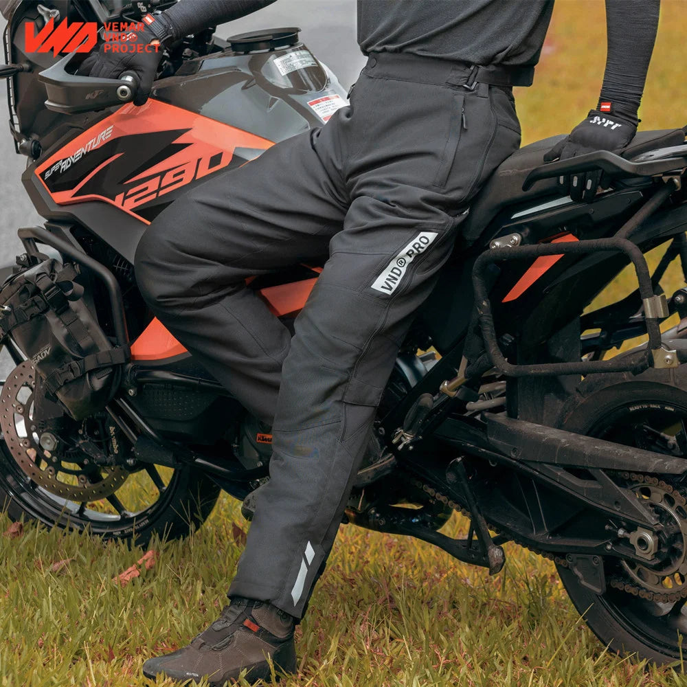 Black men's winter waterproof motorcycle overpants with CE knee pads, insulated windproof touring pants, quick-release design.