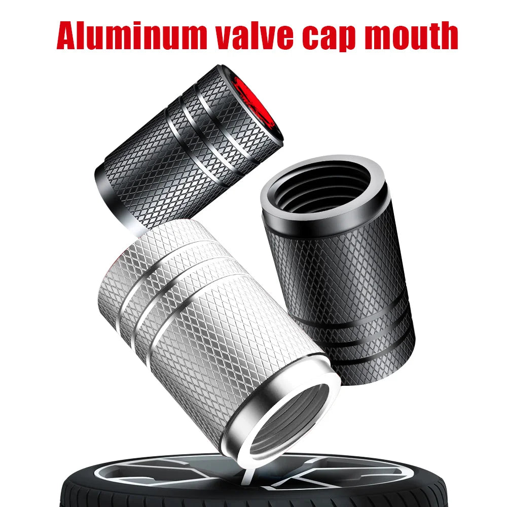 Set of four black and white aluminum tire valve stem caps for cars, bikes, and motorcycles, dustproof and universal fit.