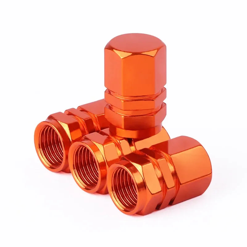Red aluminum alloy tire valve stem caps for car, motorcycle, and bicycle wheels, dustproof and corrosion-resistant.