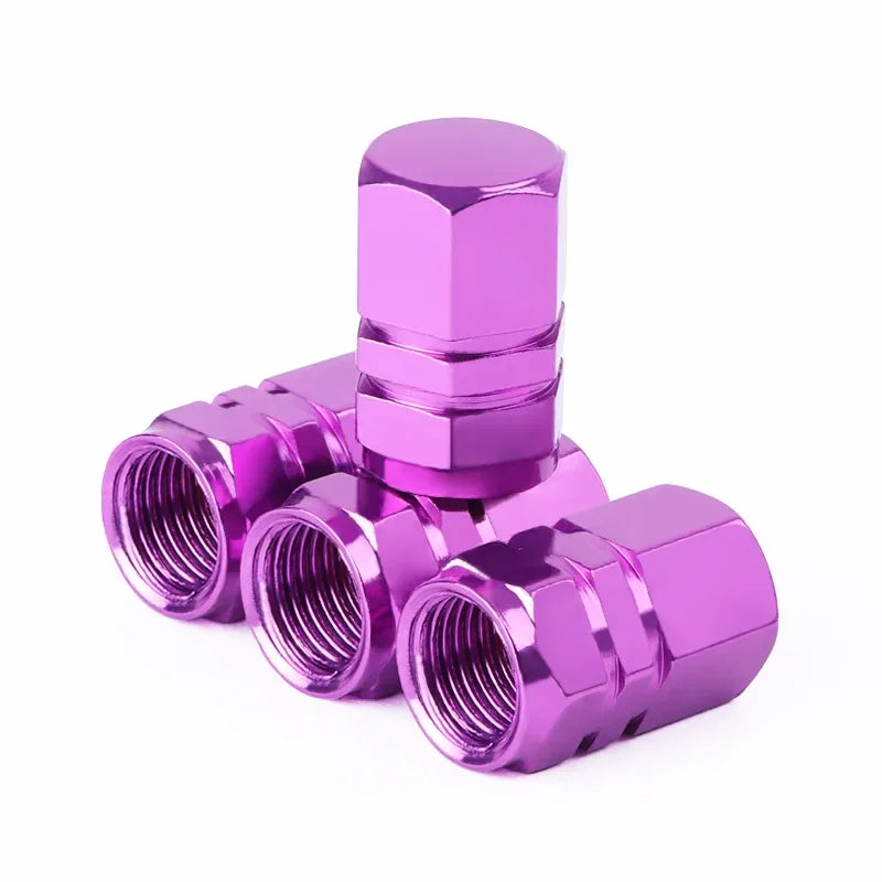 Red aluminum alloy tire valve stem caps for car, motorcycle, and bicycle wheels, dustproof and durable for outdoor use.