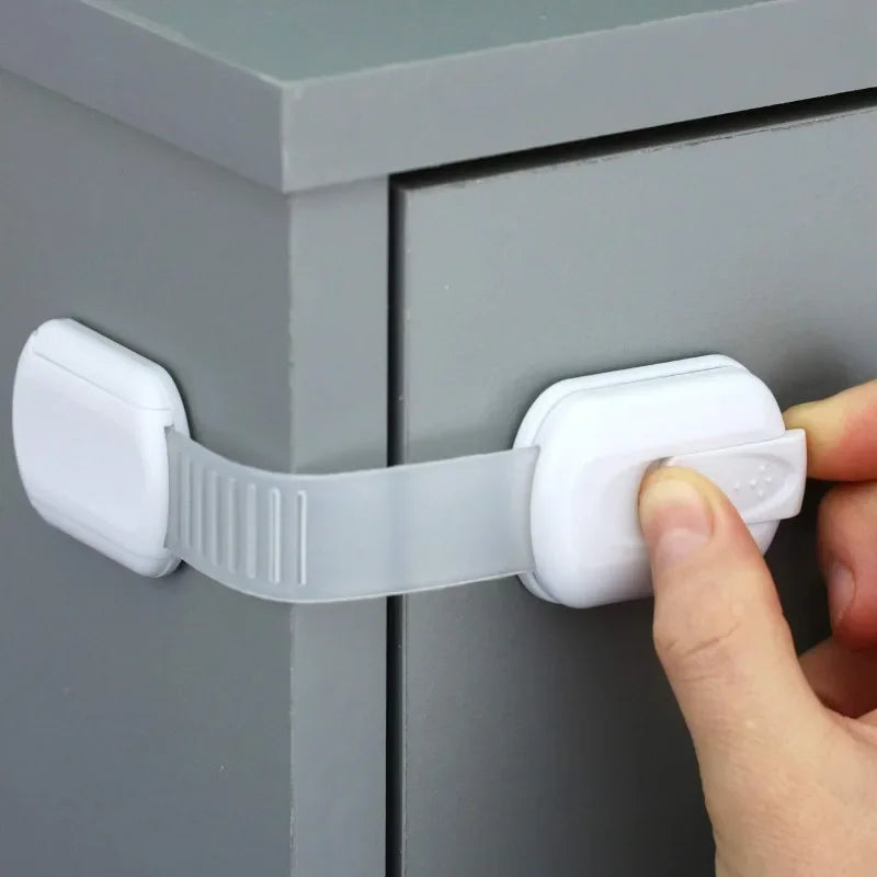 Adjustable FanzyMarket baby & childproof cabinet safety lock with adhesive strap for cabinets, drawers, and appliances.