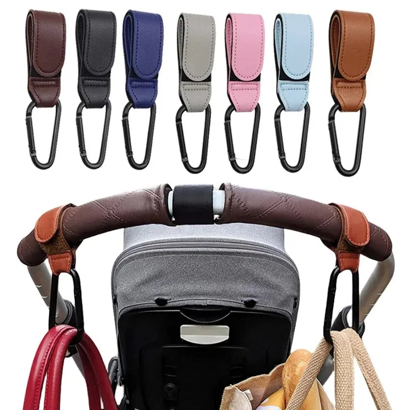 Two pink PU leather stroller hooks from FanzyMarket, adjustable and universal, for baby diaper bags and nursery organization.