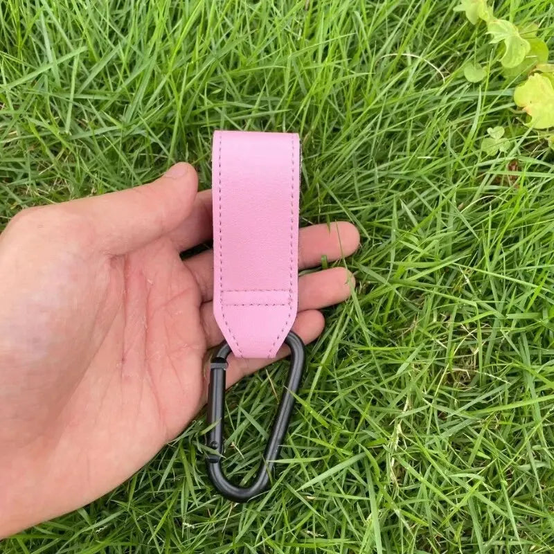 Pink PU leather stroller hooks, adjustable and universal, for baby diaper bags and nursery organization by FanzyMarket.