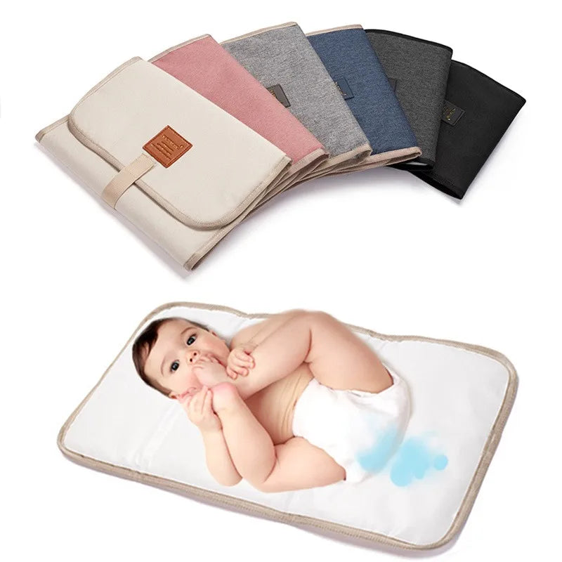Light gray foldable waterproof baby changing pad by FanzyMarket, portable diaper mat for newborns and toddlers in Oxford fabric.