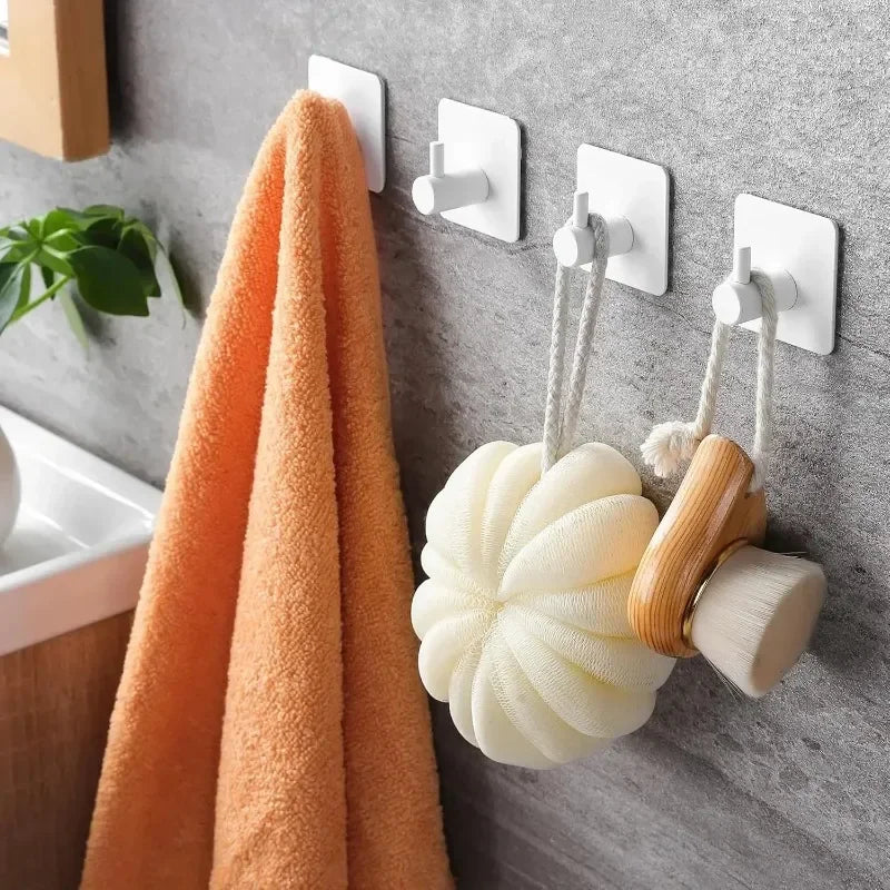 Black stainless steel adhesive wall hooks for coats, robes, and towels, shown in a 2-pack from FanzyMarket.