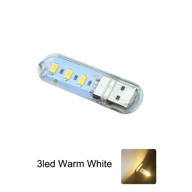 FanzyMarket mini USB LED book light with 8 warm white LEDs, portable RGB reading lamp for laptops, power banks, and notebooks.