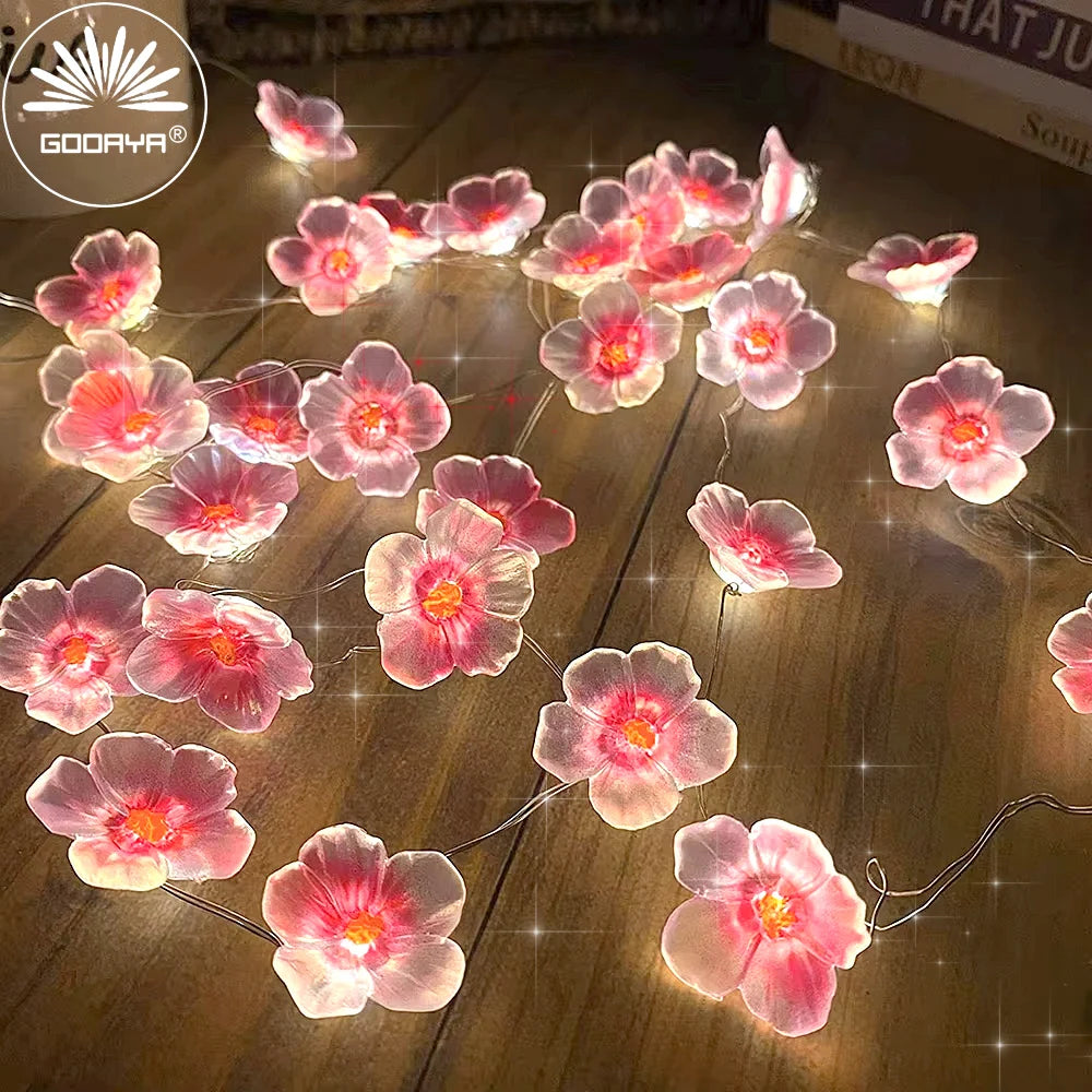 FanzyMarket 30 LED pink cherry blossom fairy string lights, battery-powered flower garland for home, bedroom, and Christmas decor.