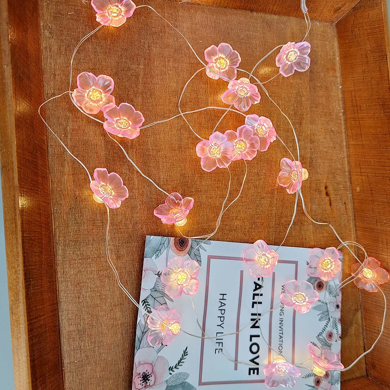 FanzyMarket 30 LED pink cherry blossom fairy string lights, battery-powered flower garland for home, bedroom, and Christmas decor.