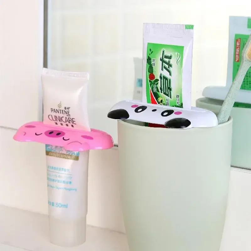 Cute cartoon animal toothpaste squeezer featuring bear and frog designs, ideal for bathroom toothpaste dispensing.