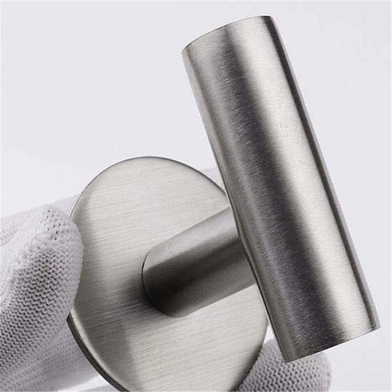 Polished silver stainless steel bathroom hardware set with towel rack, toilet paper holder, and hook for modern bathroom decor.
