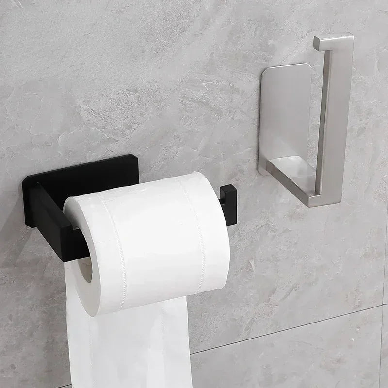 Matte black self-adhesive stainless steel toilet paper holder from FanzyMarket, wall-mounted for bathroom convenience.