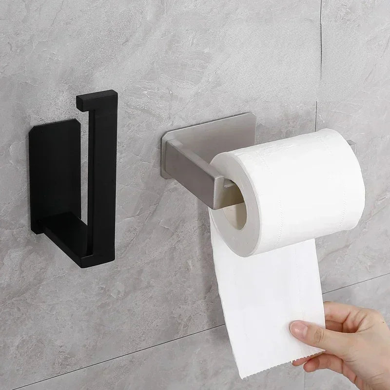 Matte black stainless steel self-adhesive toilet paper holder by FanzyMarket, wall-mounted for bathroom convenience.