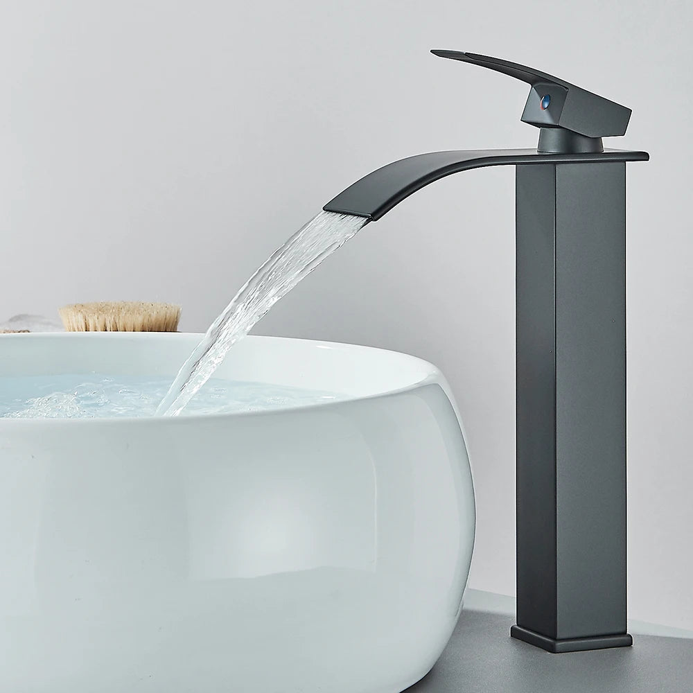 Matte black waterfall basin faucet by FanzyMarket, deck-mounted single-handle mixer tap with hot and cold water for bathroom sink.