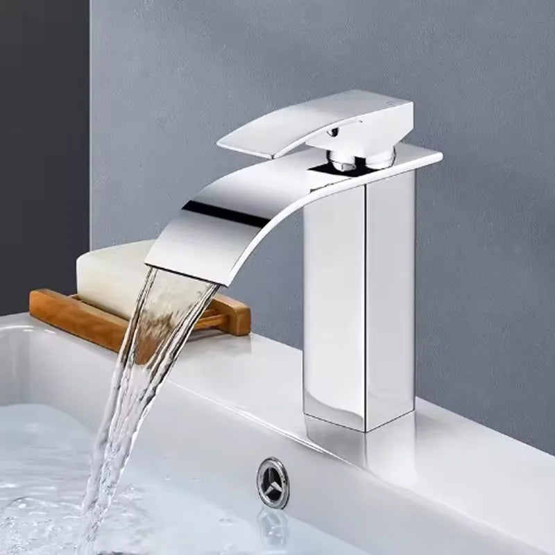 Stainless steel deck-mounted bathroom basin faucet with hot and cold handles, in classic style for home plumbing.
