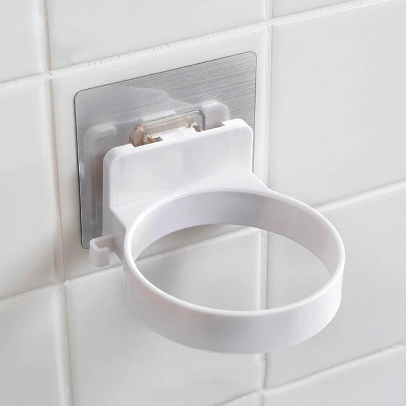 FanzyMarket stainless steel wall-mounted hair dryer holder with spiral stand, nail-free adhesive, compact 12x10 cm bathroom accessory.