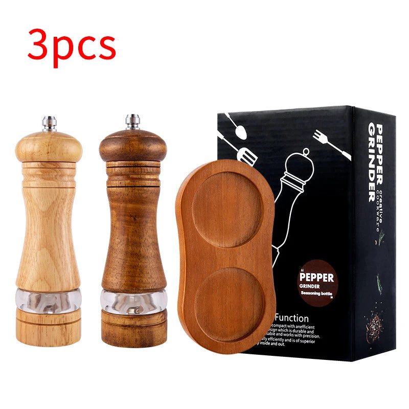 Manual Pepper Mill by FanzyMarket with acrylic and rubber wood body, ceramic core, showing freshly ground black pepper.