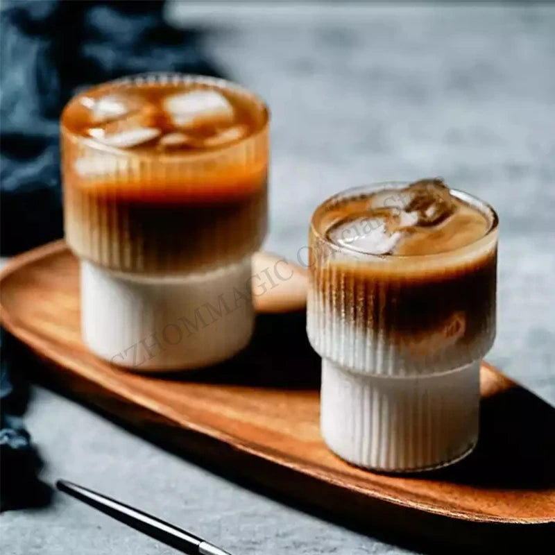Clear, handleless borosilicate glass latte mug with ribbed design, heat-resistant and suitable for coffee and beverages.