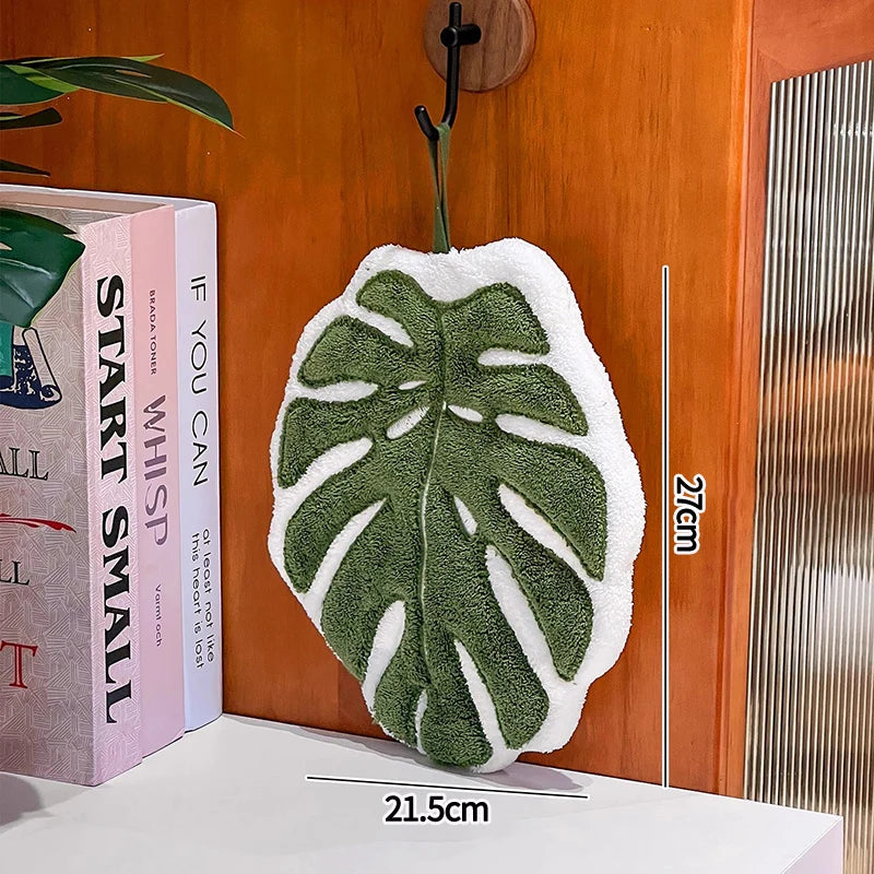 Leaf-shaped coral fleece hand towel from FanzyMarket, absorbent hanging kitchen and bathroom towel with decorative leaf design.