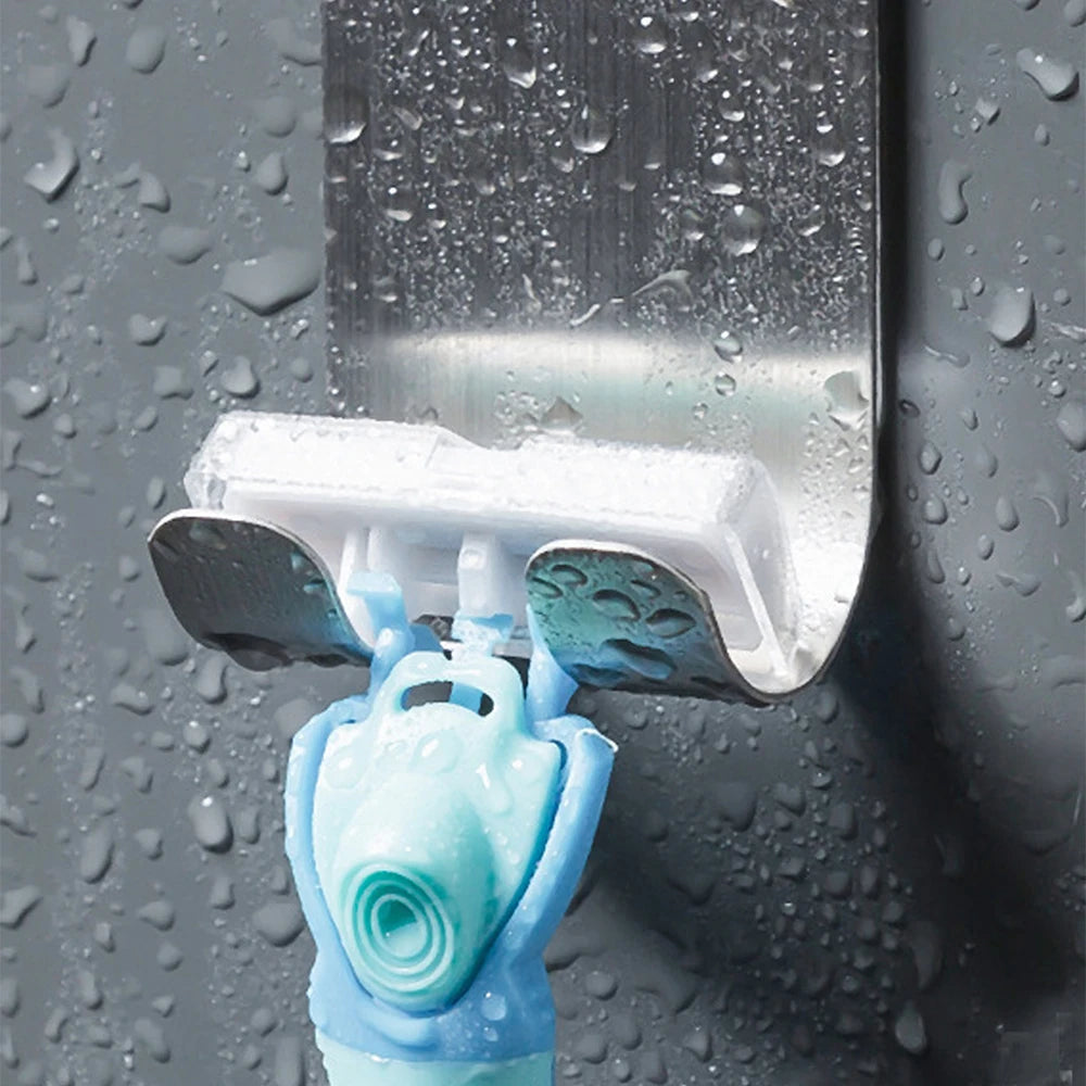Stainless steel self-adhesive razor hook with double hooks for wall mounting in bathroom or kitchen organization.
