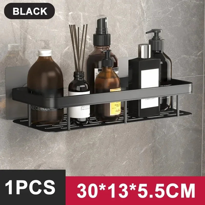 Black and gold FanzyMarket no-drill aluminum alloy bathroom shower shelf and kitchen organizer mounted on wall with shampoo bottles.