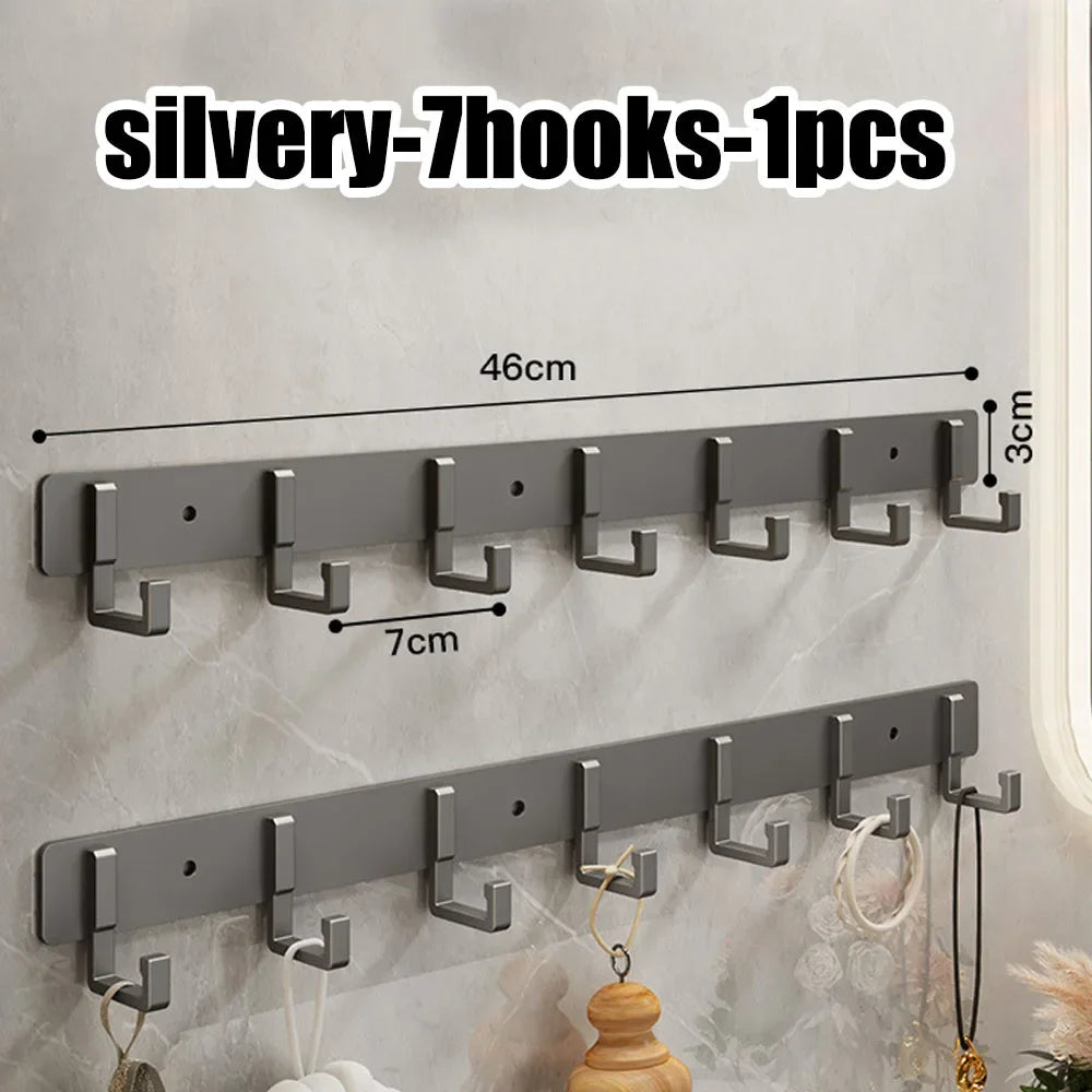 Stainless steel wall-mounted multi-hook with seven hooks for towels and clothes, no-drill adhesive design for bathroom or kitchen.