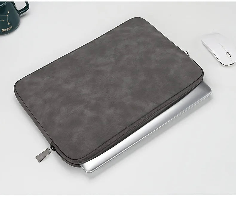 FanzyMarket light gray PU leather laptop sleeve for 11-15 inch laptops, slim and protective case for office and tech accessories.