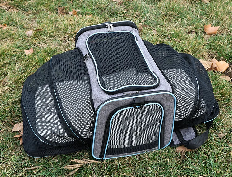 FanzyMarket foldable mesh pet carrier for cats and small dogs, soft-sided, breathable, expandable travel tote with handle.