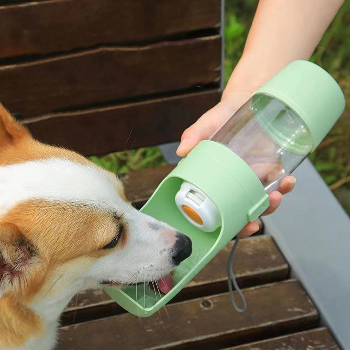 Pink portable 500ml pet water bottle with food storage and foldable bowl, ideal for travel with dogs and cats.