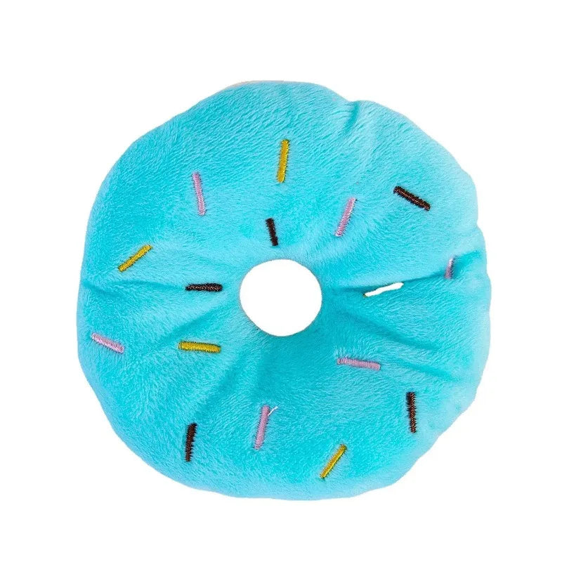 Pink plush donut chew toy with squeaker for small and medium dogs, made of soft fleece, 4.3 inches in size.