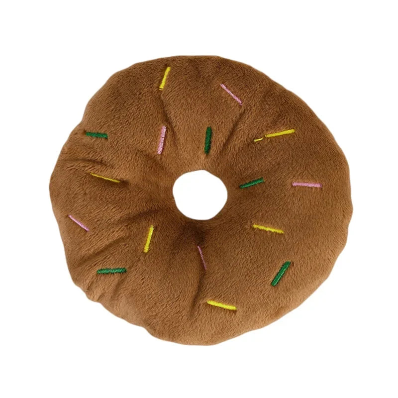 Pink plush donut chew toy with squeaker for small and medium dogs, soft fleece material, 4.3 inches in size.