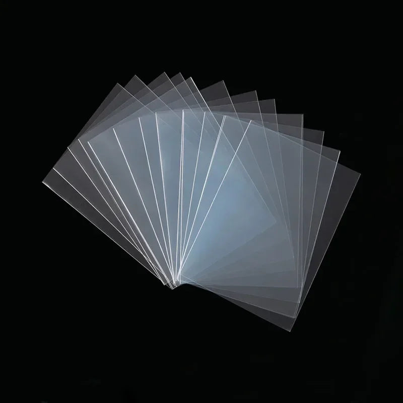 Set of 100 clear mixed-size card sleeves by FanzyMarket for trading cards, tarot, poker, and board games.