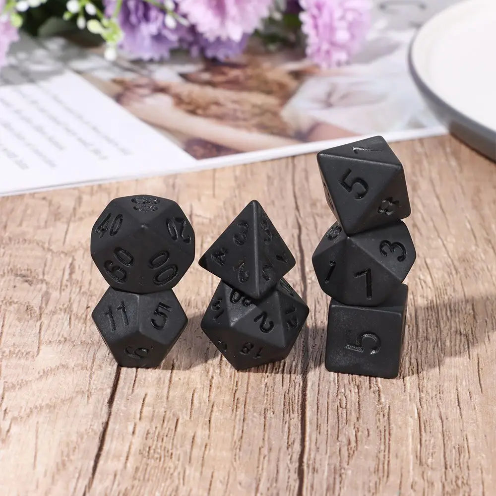 Black polyhedral dice set for D&D and tabletop RPGs, including various numbered dice for board and card games by FanzyMarket.