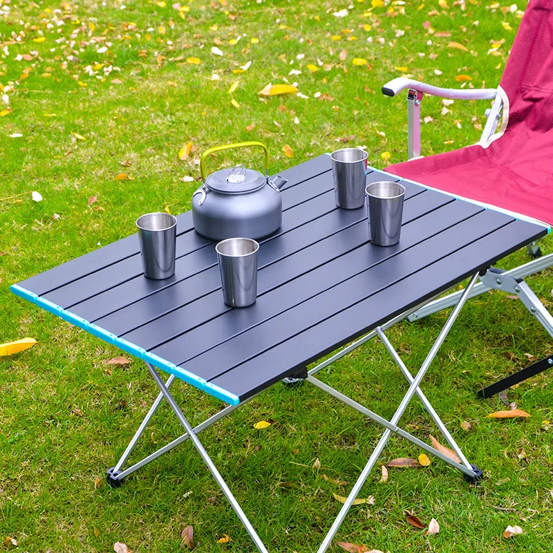 FanzyMarket ultralight portable folding camping table made of high-strength aluminum, ideal for picnics, BBQs, and outdoor activities.