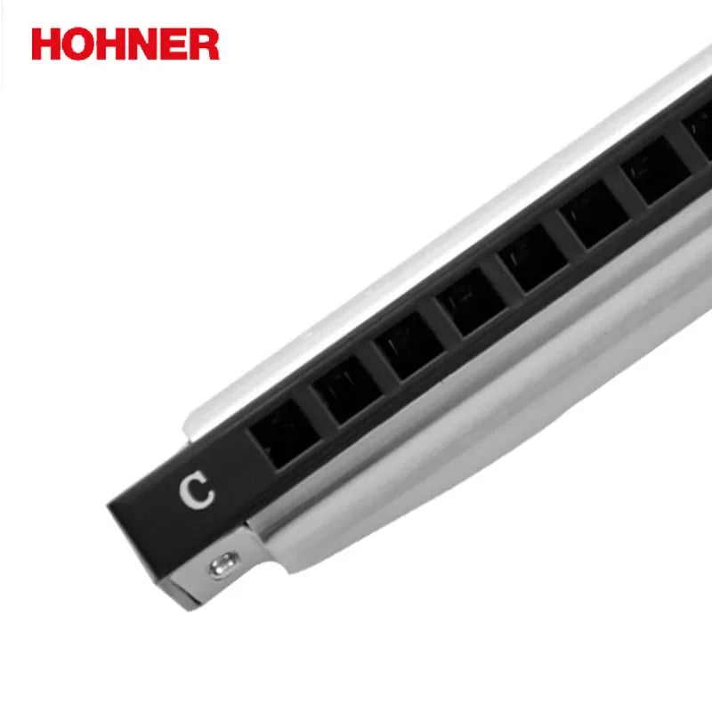 Close-up of the Hohner Silver Star harmonica's 10 holes and chrome cover plate