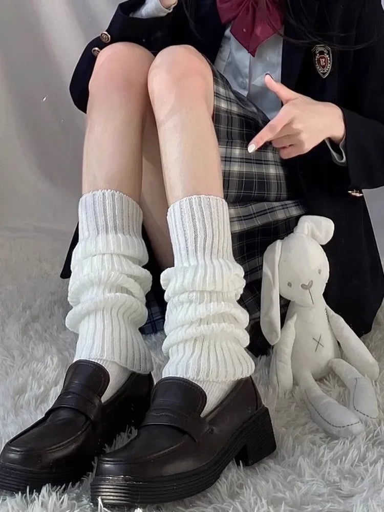 Women's Y2K knit leg warmers by FanzyMarket, black and white crochet boot cuffs, 50cm length, styled on a model.