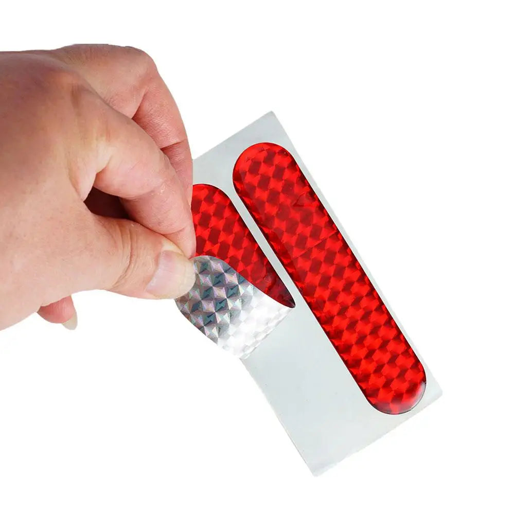 Two red reflective car door safety stickers from FanzyMarket, interior warning tape, 10.6 x 2.3 cm, for auto and moto safety.