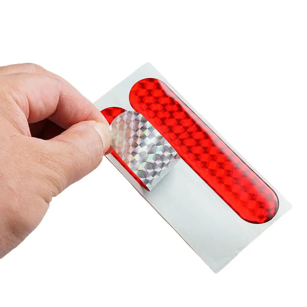 Two red reflective car door safety stickers by FanzyMarket, interior warning reflector tape, 10.6 x 2.3 cm, for auto and moto safety.