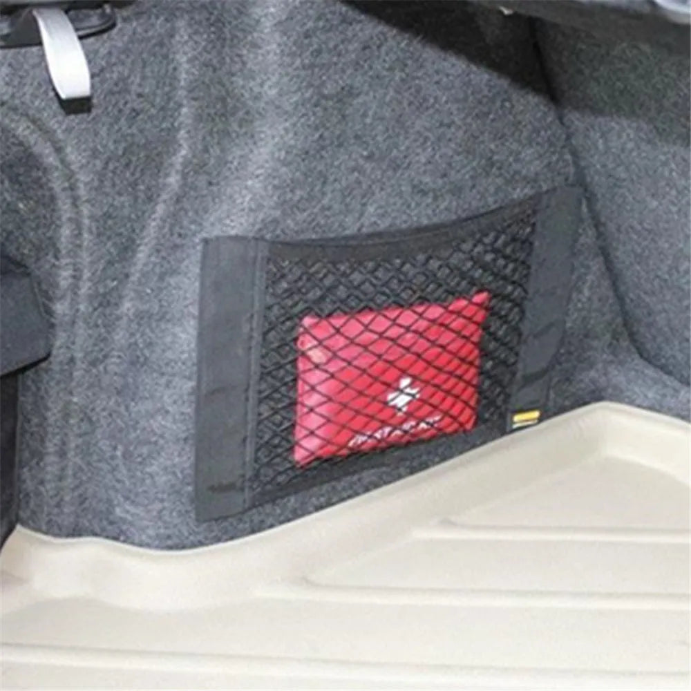 FanzyMarket car trunk storage mesh net bag, 40x20 cm, adhesive elastic organizer, universal fit for auto interior and phone mounts.