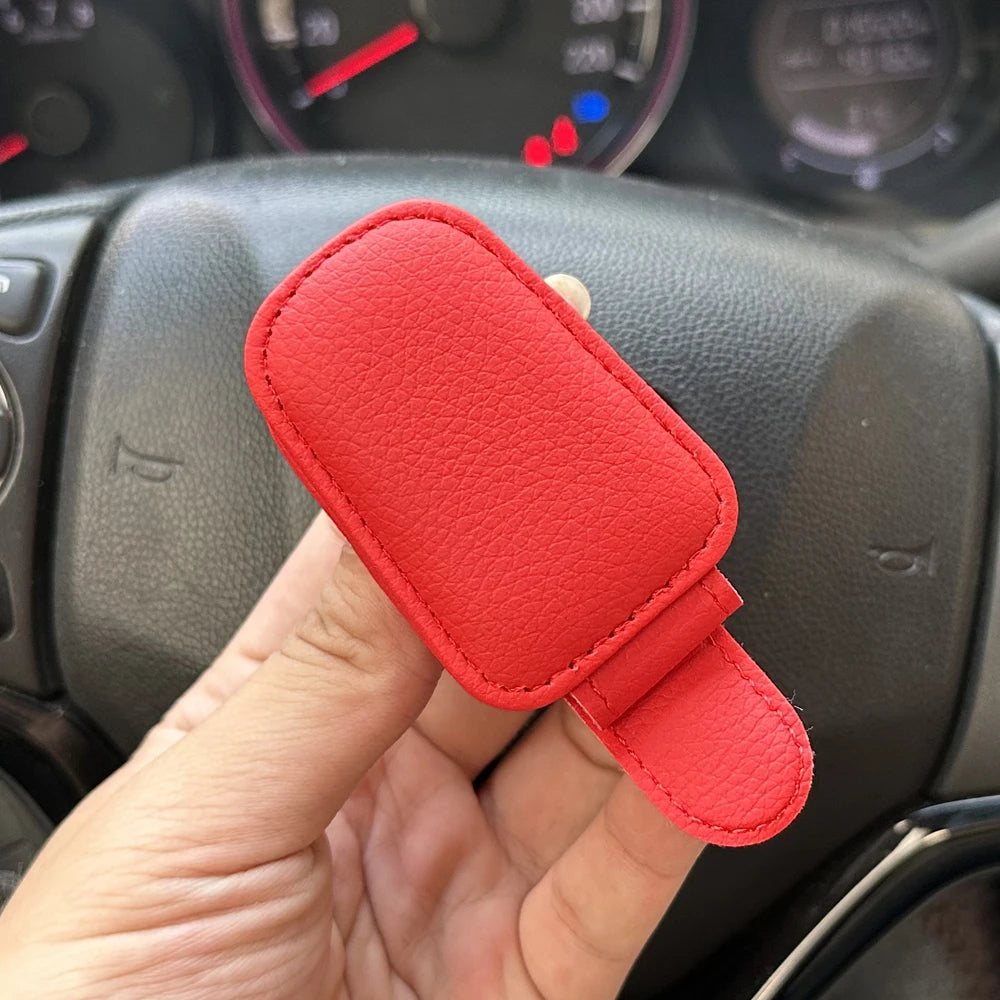 FanzyMarket magnetic car sunglasses holder with foldable leather design, fits sun visors, holds glasses, cards, and tickets inside vehicle.