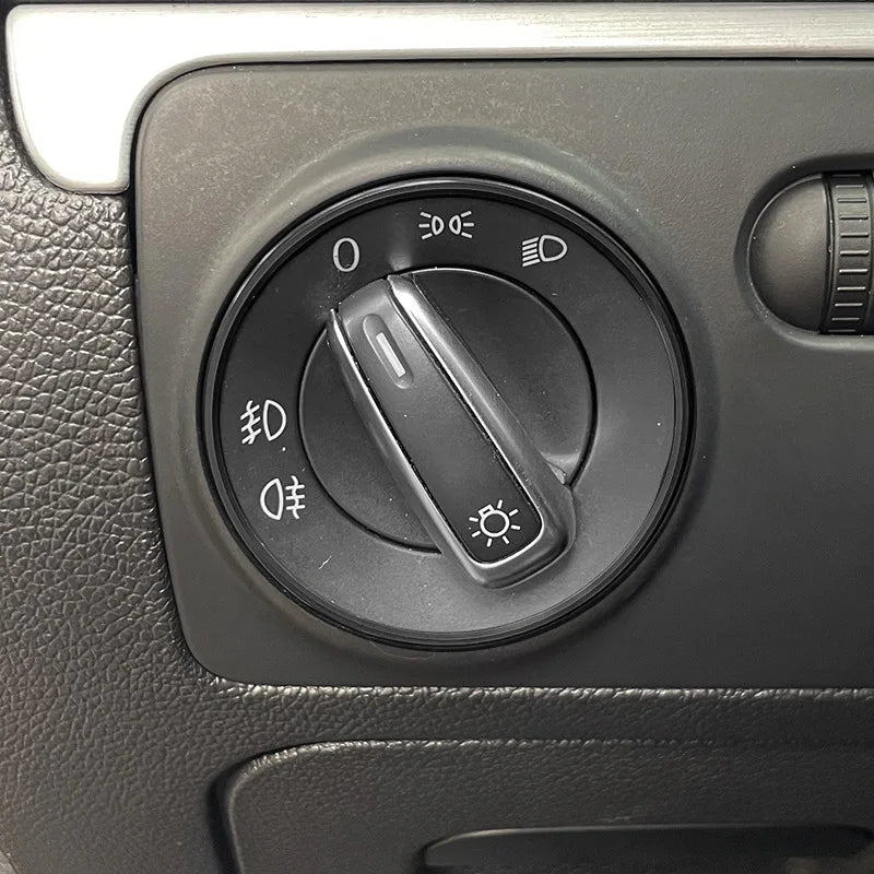 Silver metal headlight switch trim ring for Volkswagen Golf, Passat, and Polo interior switch cover by FanzyMarket.