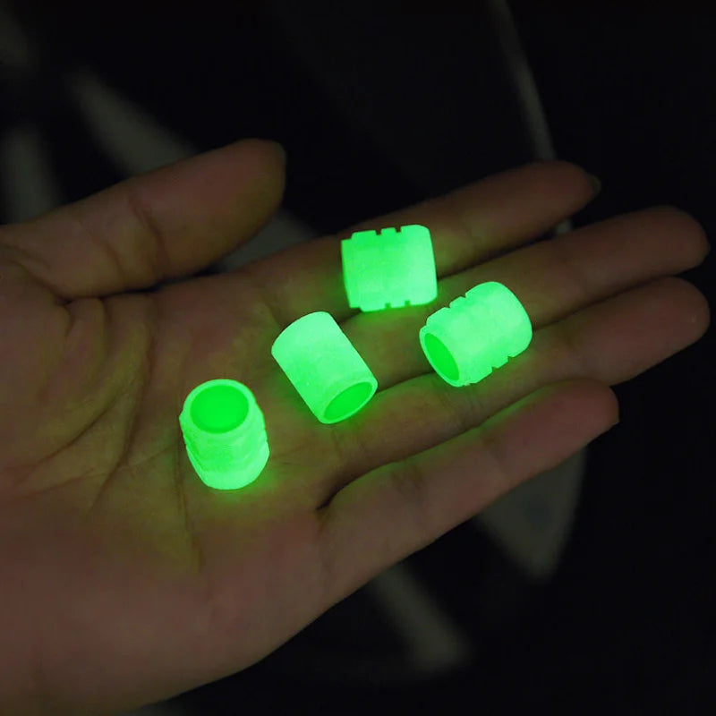 Set of four green glow-in-the-dark tire valve caps for cars, motorcycles, and bicycles, featuring luminous and fluorescent wheel valve stems.