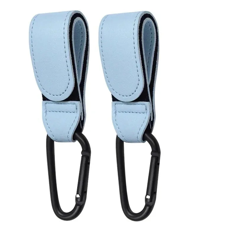 Two pink PU leather stroller hooks by FanzyMarket, adjustable pram bag hangers for baby care and diaper bag organization.