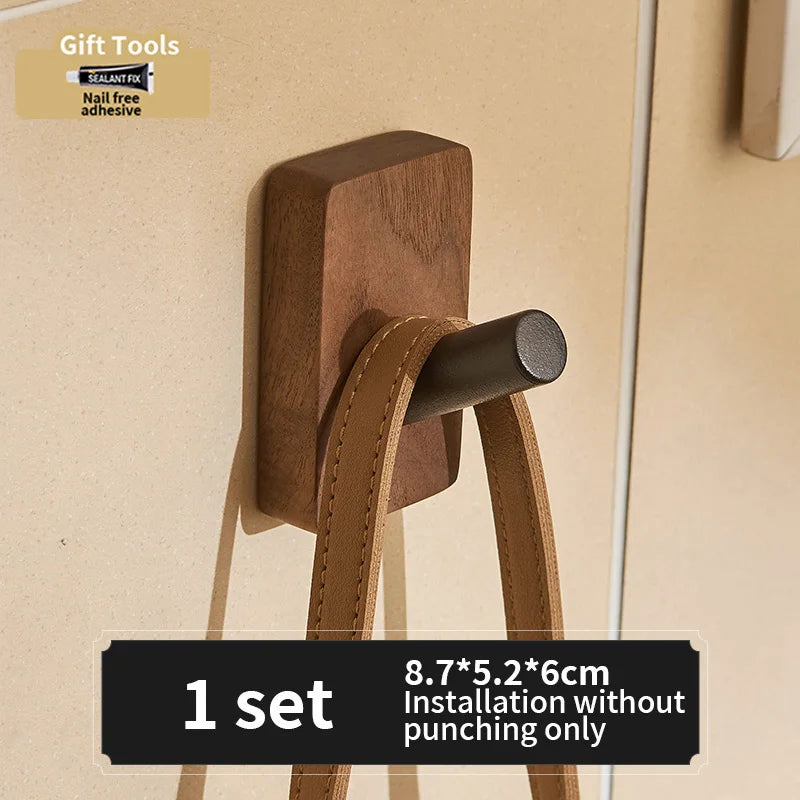 Black walnut aluminum adhesive wall-mounted robe hook by FanzyMarket, holding towels, coats, and bags with up to 3 hooks.