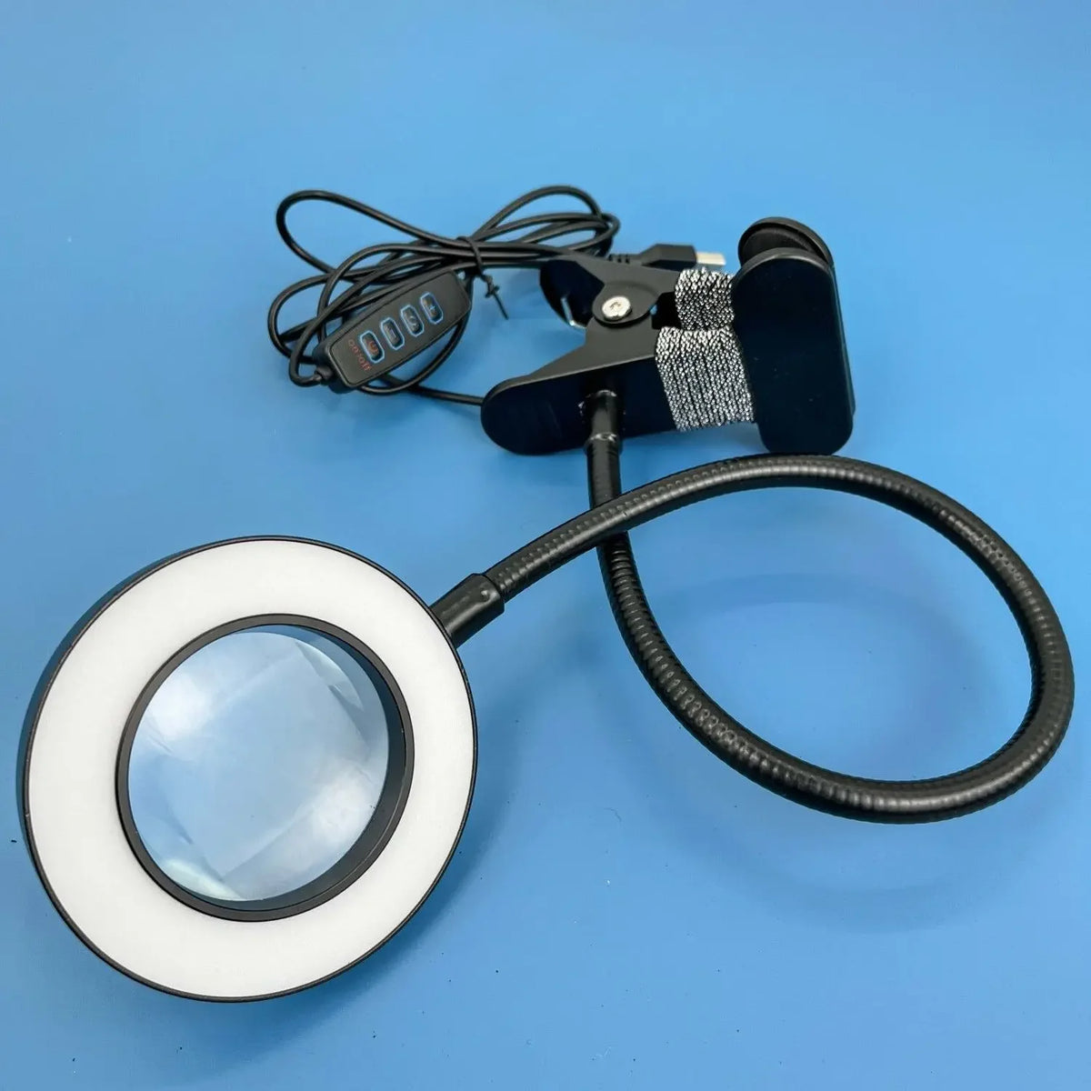 10X clip-on magnifying lamp with LED light in black, white, and silver for detailed work like manicures and embroidery
